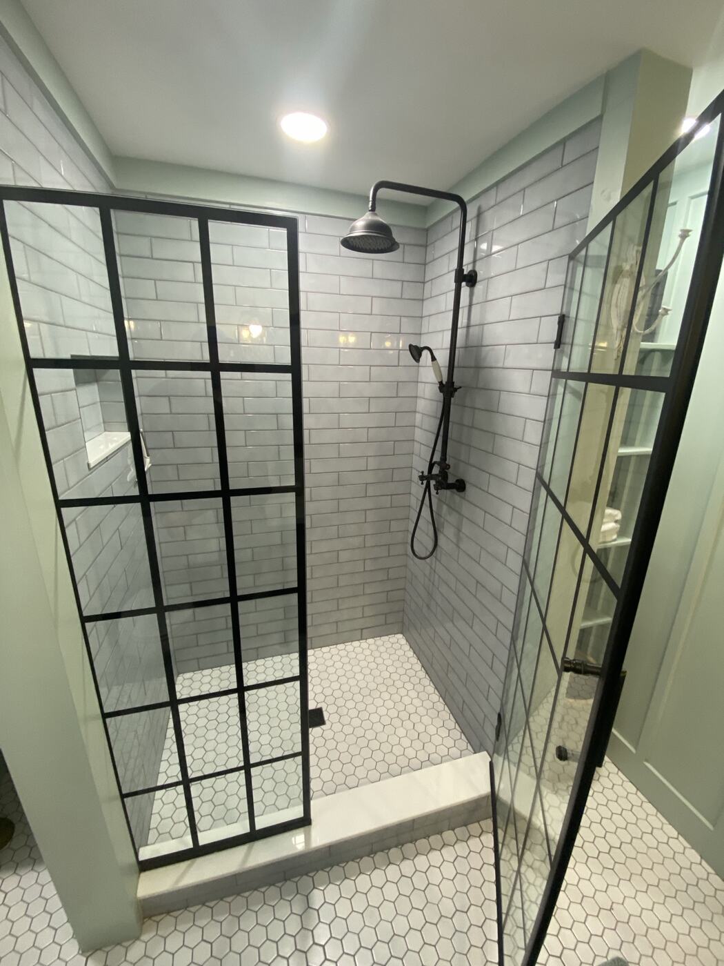 Bathroom with black-framed glass shower